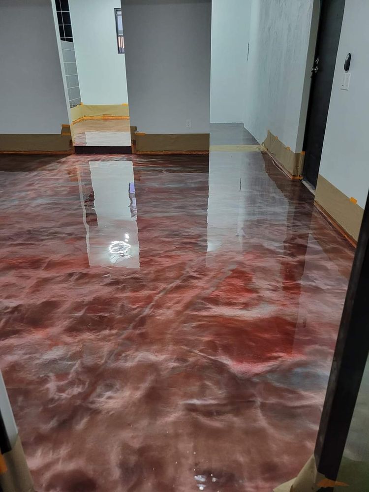 Metallic red and brown epoxy flooring with glossy finish in a room.