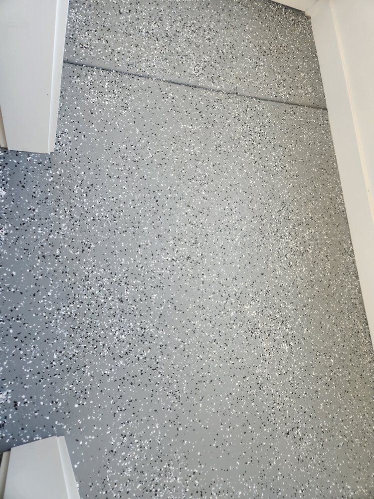 Gray speckled epoxy floor.