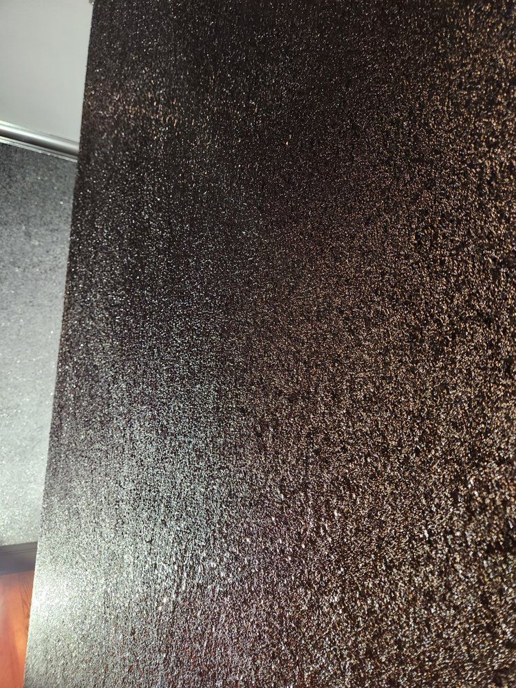 Dark brown textured surface with sparkling highlights.