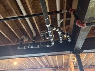 Overhead view of a plumber repairing a sink.