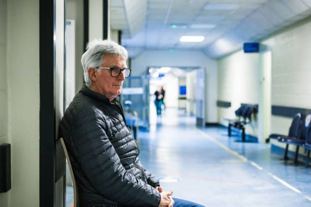 Sunrise Hospital. Patient-114. Stock photo of man waiting in the hospital hallway.