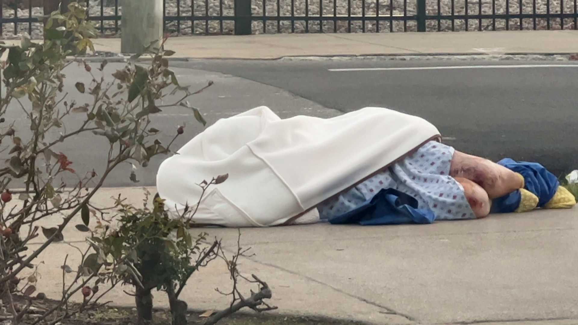 Sunrise Hospital, Patient-144, stock photo showing a patient laying on the ground outside a hospital