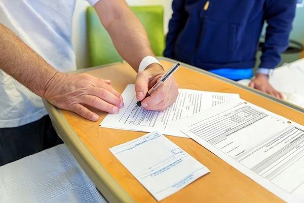 Sunrise Hospital. Stock photo of a patient signing an AMA form and leaving the hospital.