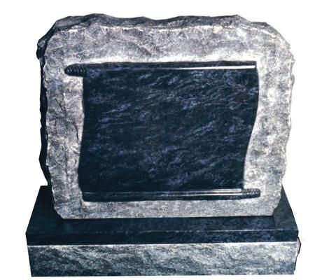 A black gravestone with a scroll on it