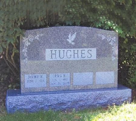 A gravestone for hughes in a cemetery with a dove on it.