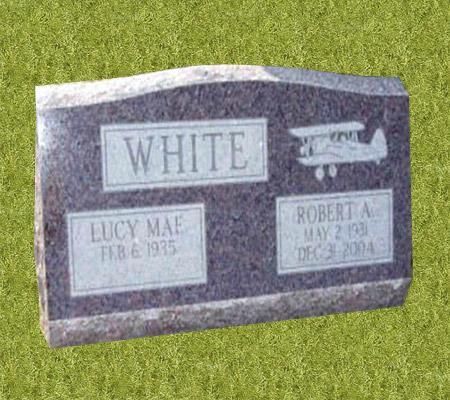 A gravestone with the name white and lucy mae on it