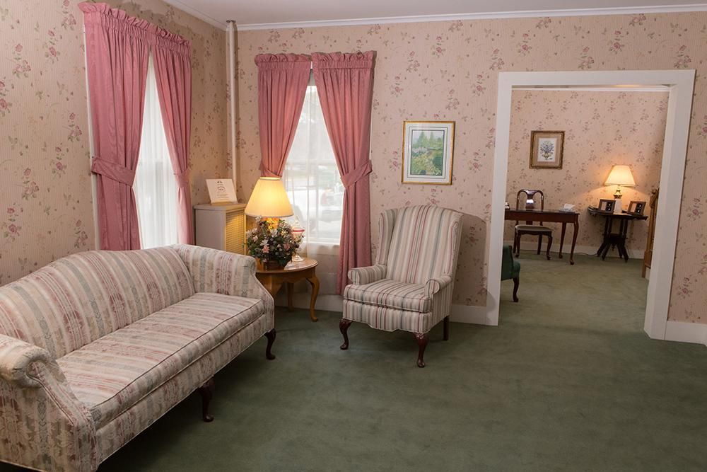 A living room with a couch and two chairs