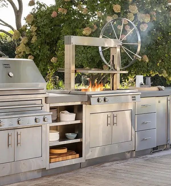 A kitchen with stainless steel cabinets and a grill
