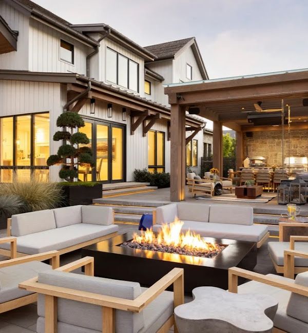 A patio with a fire pit in the middle of it