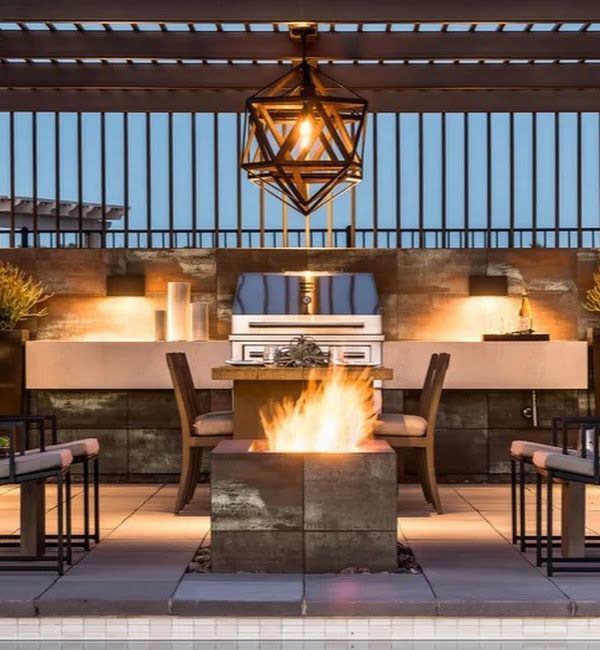 A patio with a fire pit and a grill