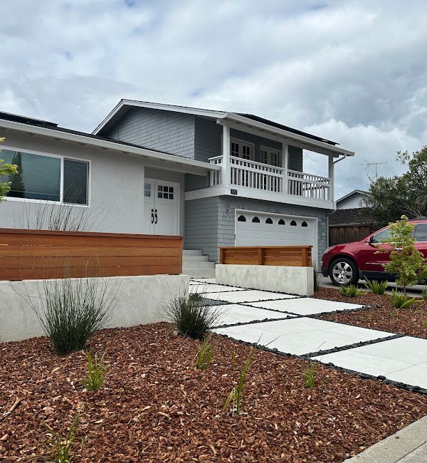 A house with a red car parked in front of it
