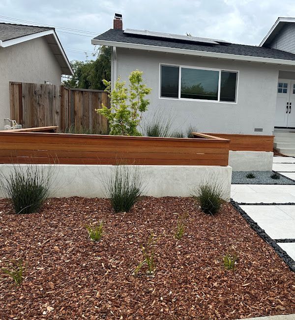 A white house with a wooden fence in front of it