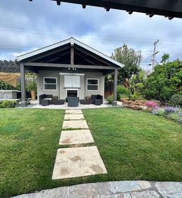 A house with a stone walkway leading to it