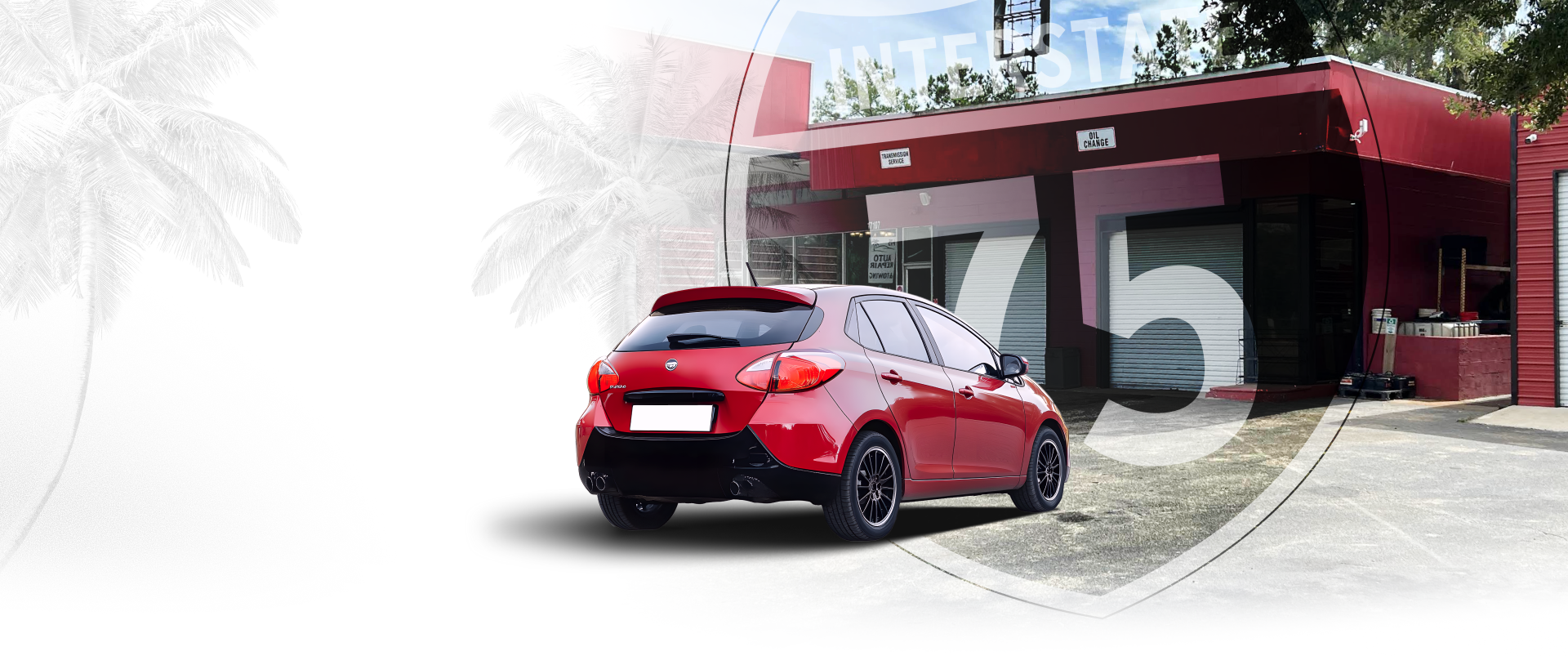 Red car parked outside of a building with number 75 on the side | I-75 Auto Repair and Towing