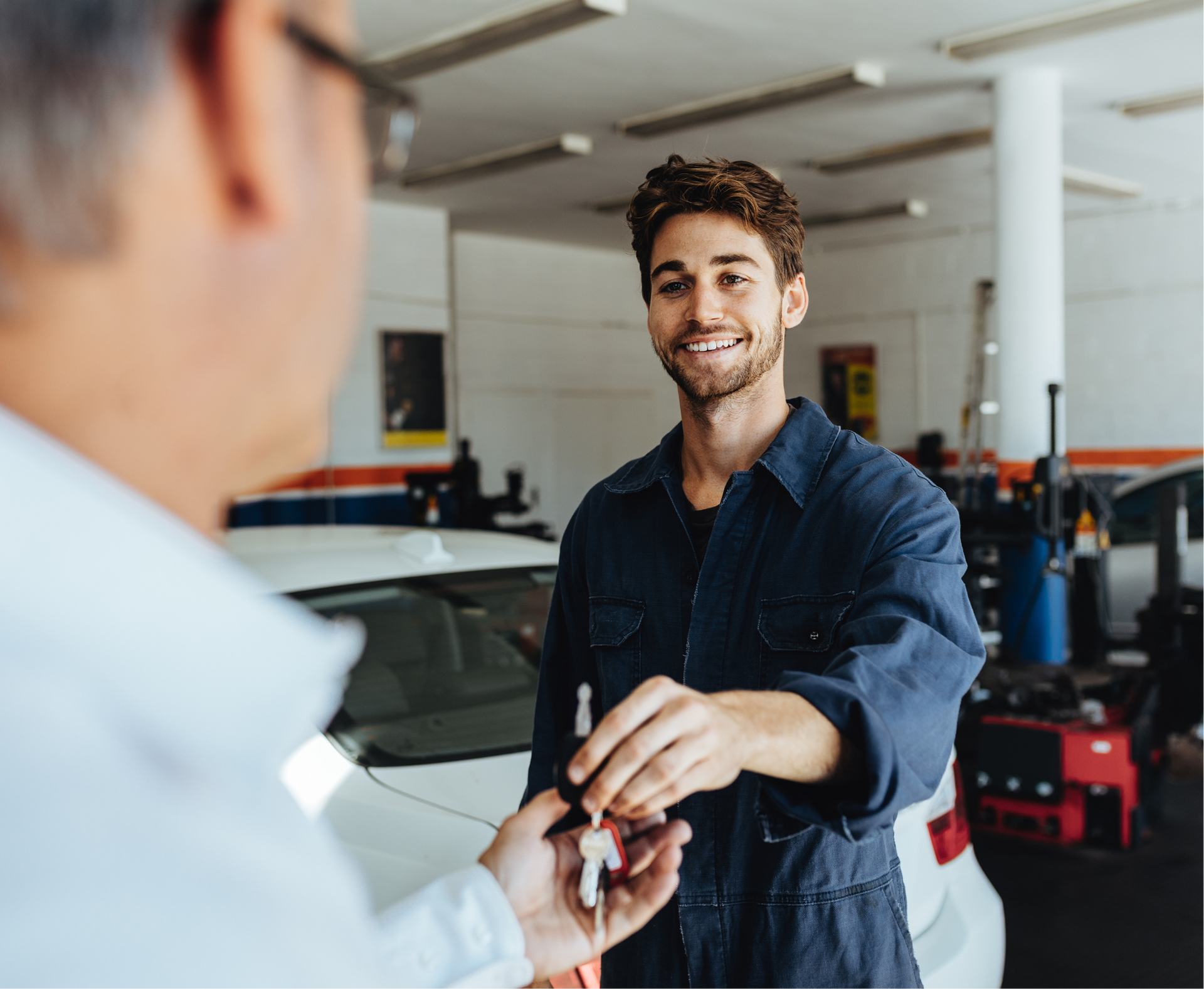 Mechanic hands car keys to a customer in a car repair shop | I-75 Auto Repair and Towing