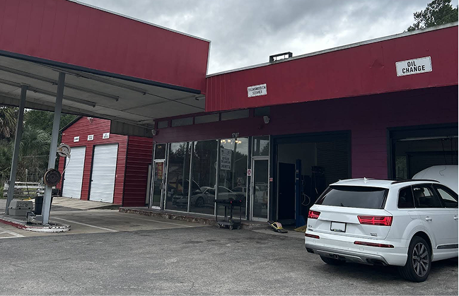 Red automotive repair shop with car parked out front | I-75 Auto Repair and Towing