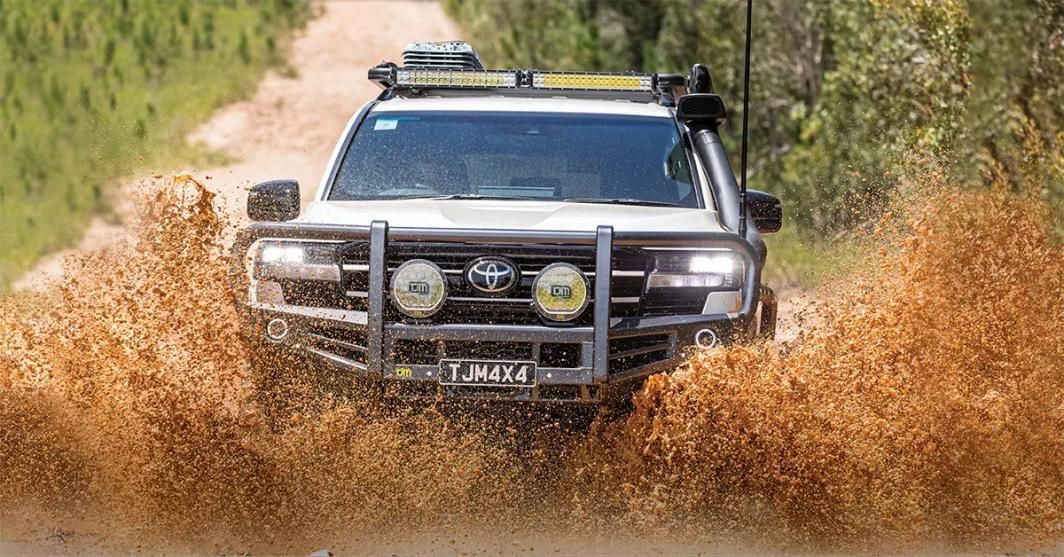 A Truck Is Driving Through A Puddle Of Mud On A Dirt Road — TJM Dubbo In Bourke, NSW