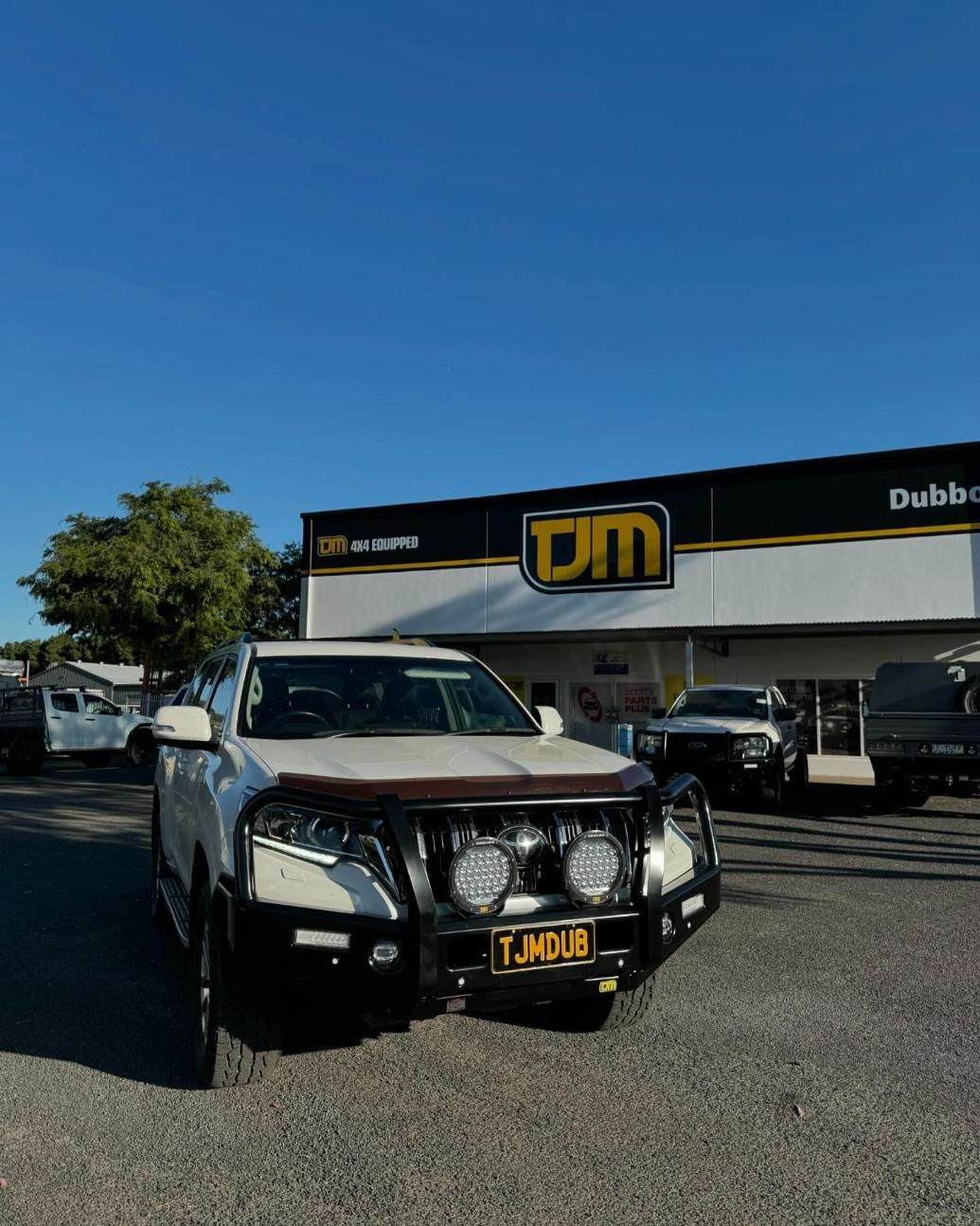A White SUV Is Parked In Front Of A TJM Store — TJM Dubbo In Condobolin, NSW