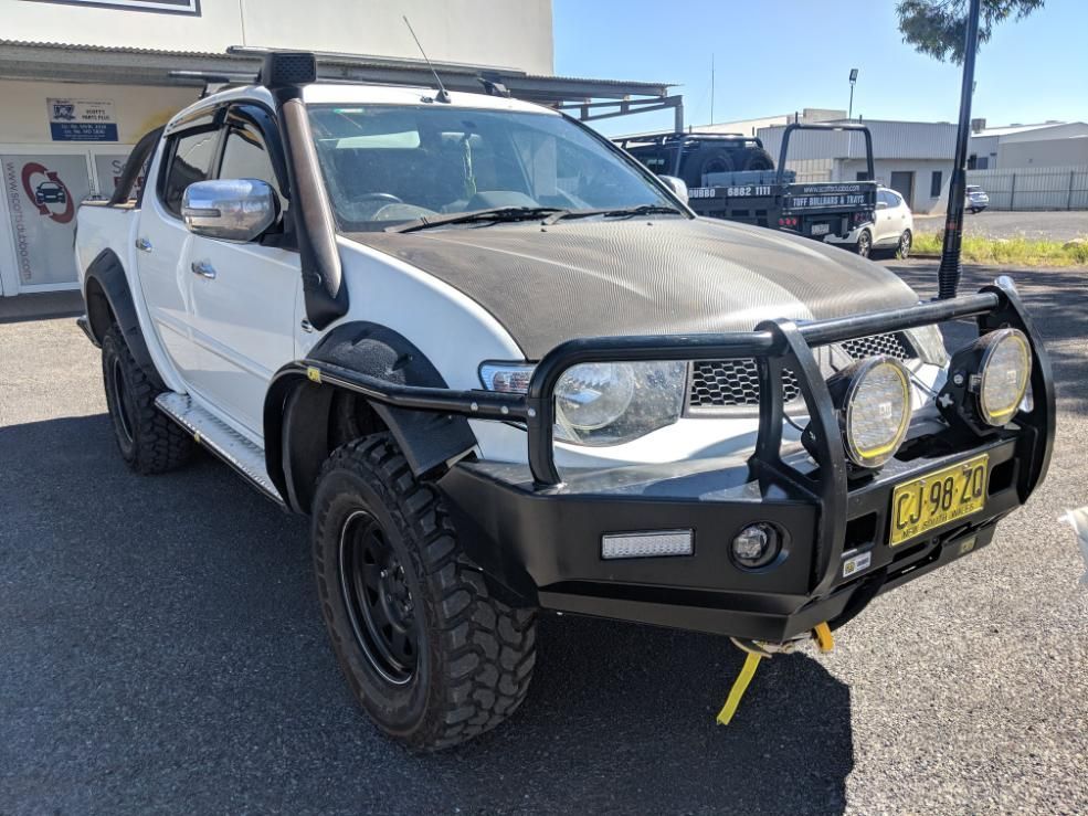 A White Truck With A Black Hood Is Parked In A Parking Lot — TJM Dubbo In Coonamble, NSW