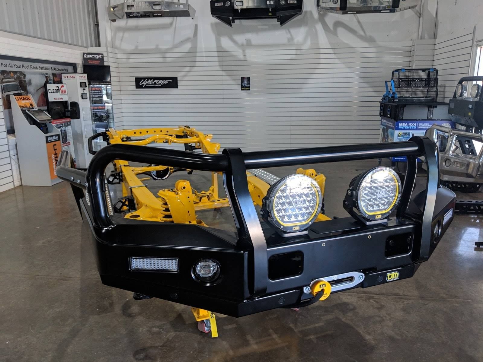 A Black Bumper With Two Lights On It Is In A Garage — TJM Dubbo In Dunedoo, NSW