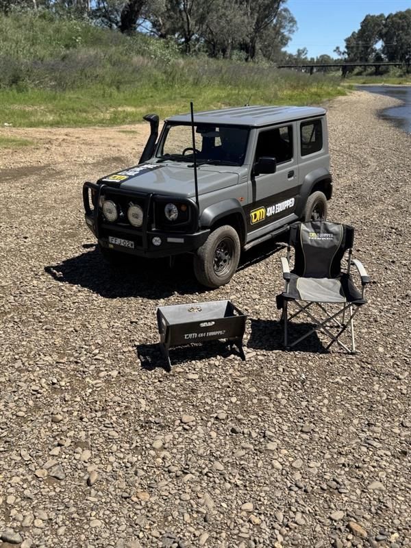 A Silhouette Of Two Men Standing Next To A Car At Sunset — TJM Dubbo In Dubbo, NSW