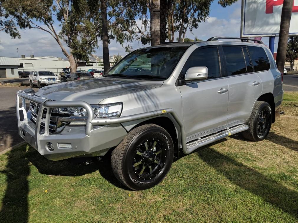 A Silver Land Cruiser Is Parked On The Grass In Front Of A Building — TJM Dubbo In Nyngan, NSW