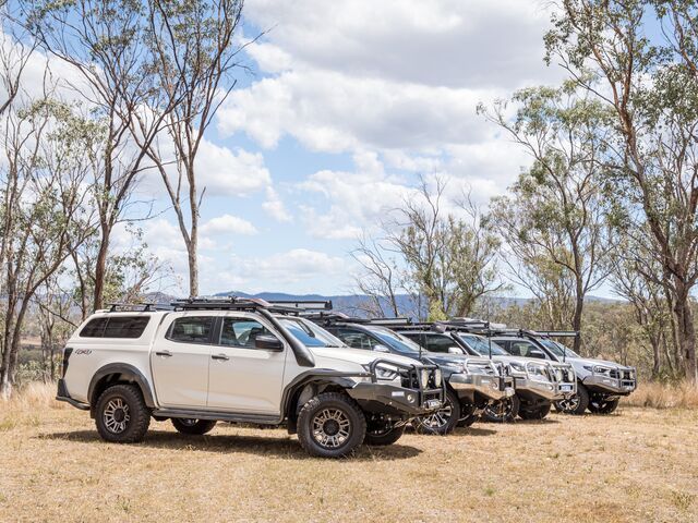 A Row of White Trucks Are Parked in a Field — TJM Dubbo In Dubbo, NSW