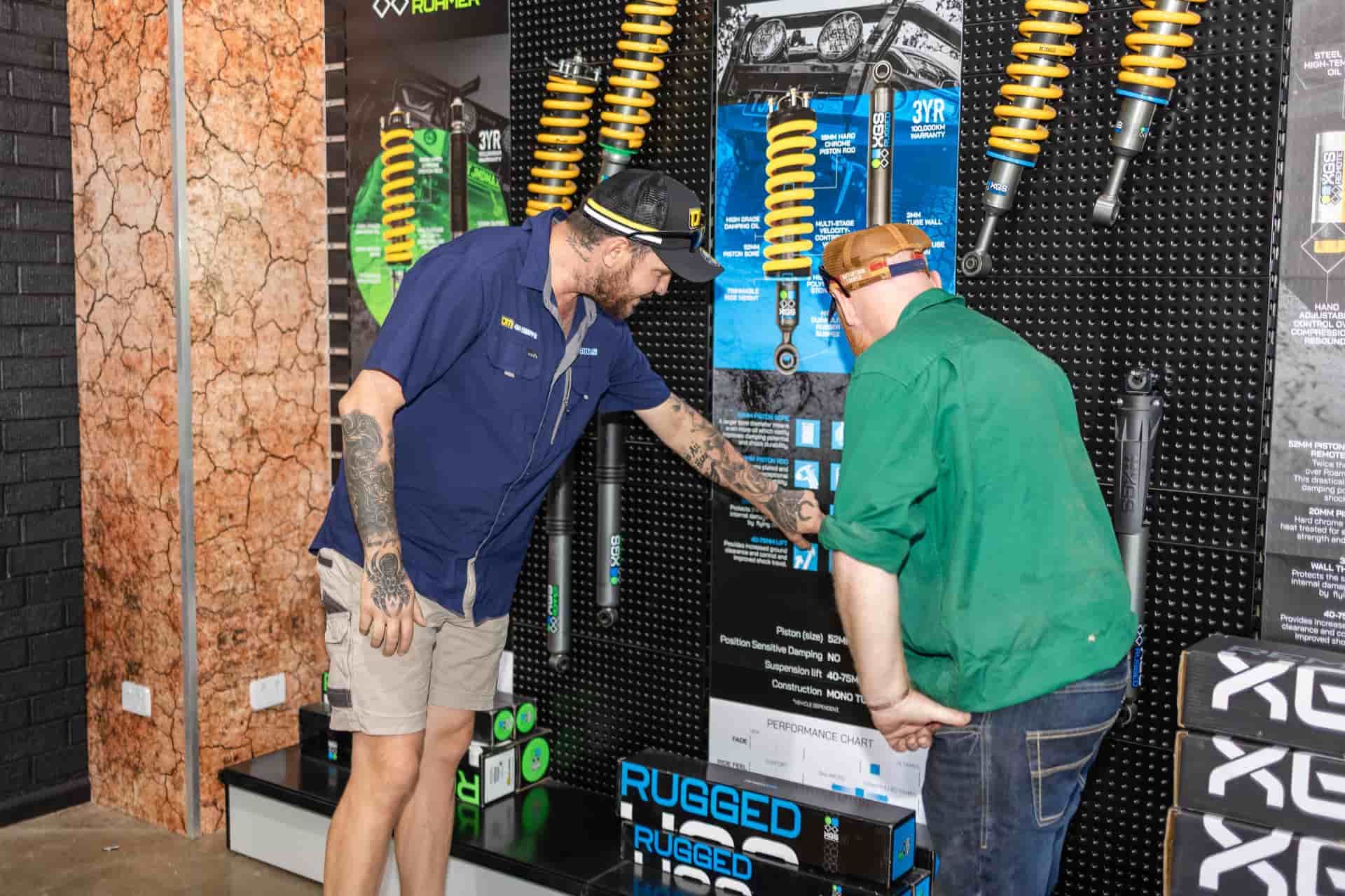 Two Men Inspect Suspension Parts — TJM Dubbo In Dubbo, NSW