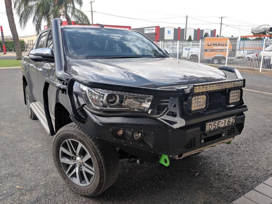 A Black Truck With A Snorkel Is Parked In A Parking Lot — TJM Dubbo In Warren, NSW