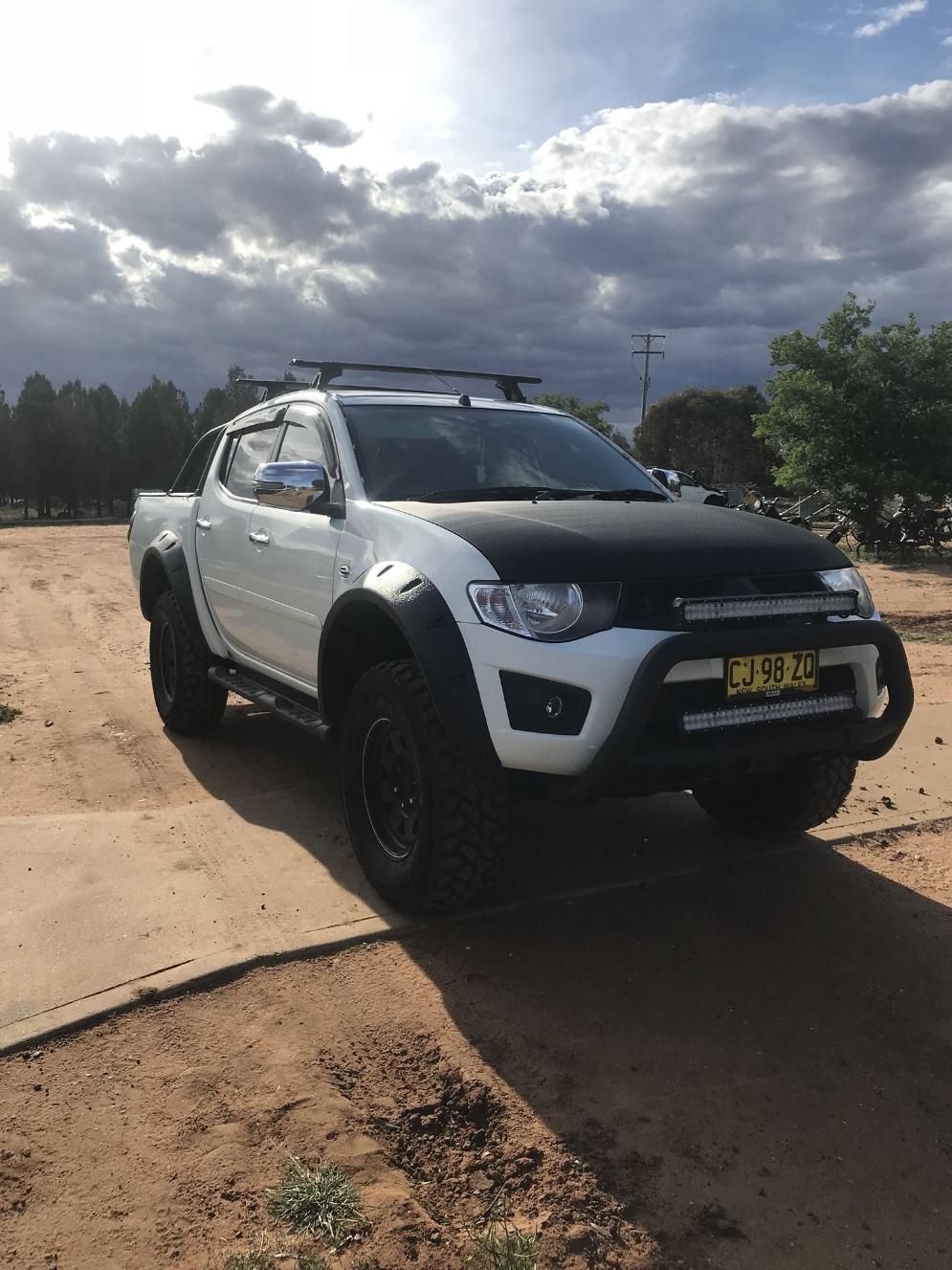 A White Truck With A Black Hood Is Parked On A Dirt Road — TJM Dubbo In Warren, NSW