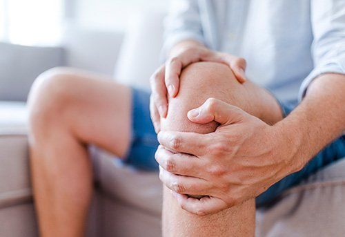 Man Holding on His Knee — Pensacola, FL — Pensacola Podiatry P.A.