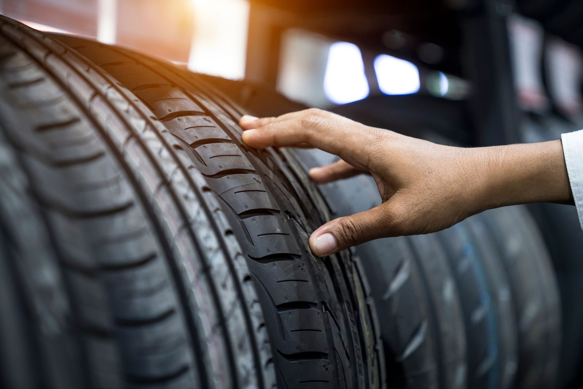 A man choosing tyres at a car dealership, selecting the best options for his vehicle.