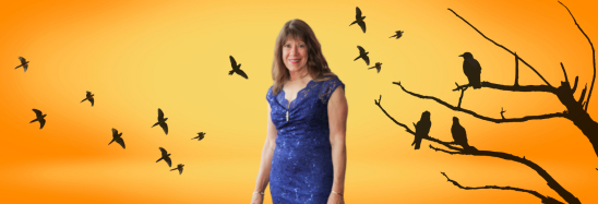 A woman in a blue dress stands in front of a tree with birds flying around her