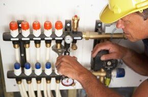 Plumber fixing valves — Plumbing Company in Phoenix, AZ