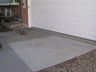 Before drive way leveling — Concrete patios in Brighton, CO