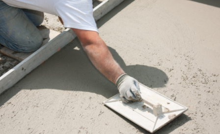 Concrete worker smoothing concrete surface