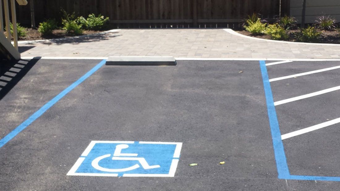 A handicapped parking space with a blue line