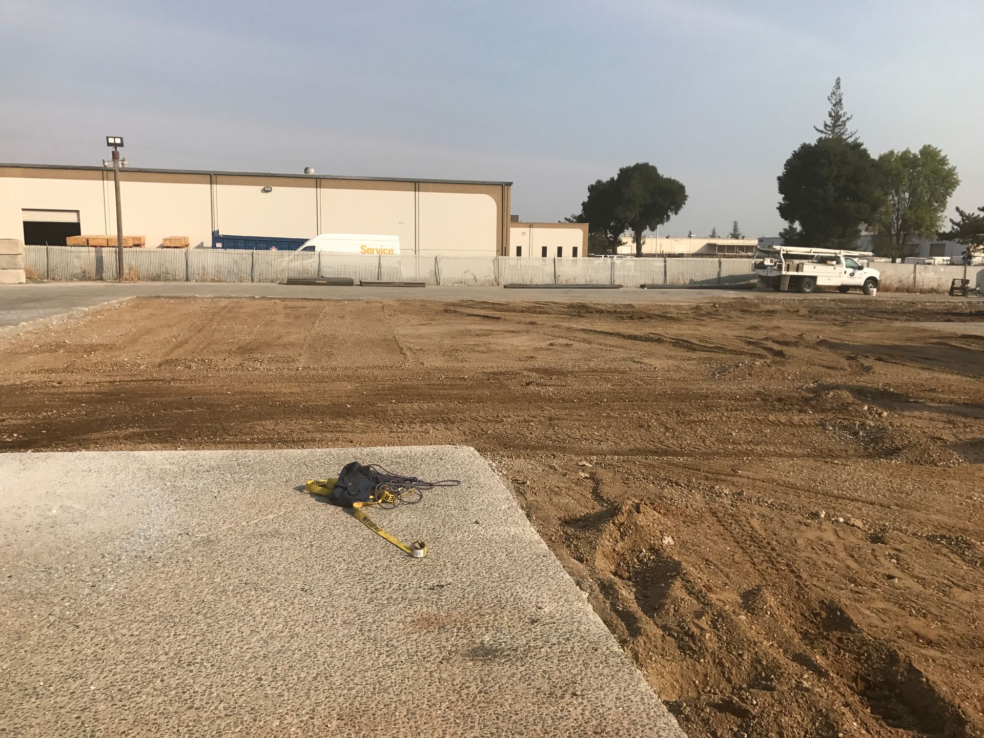 A measuring tape is laying on the ground in front of a building