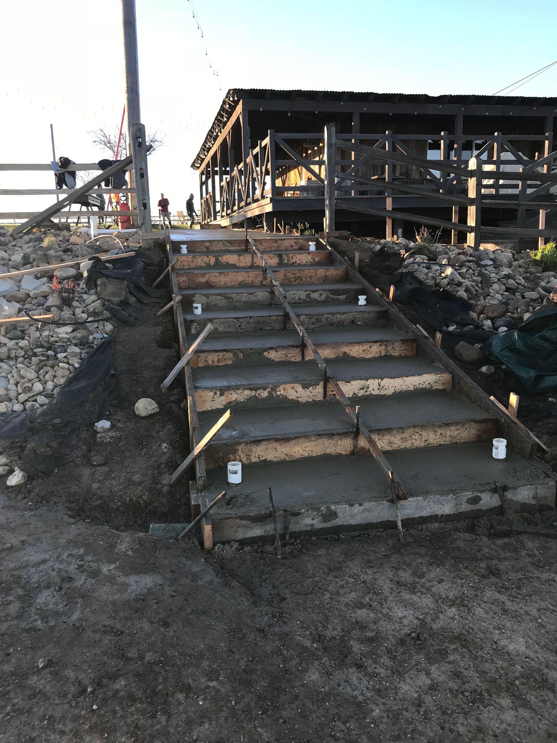 A concrete staircase is being built in front of a building.