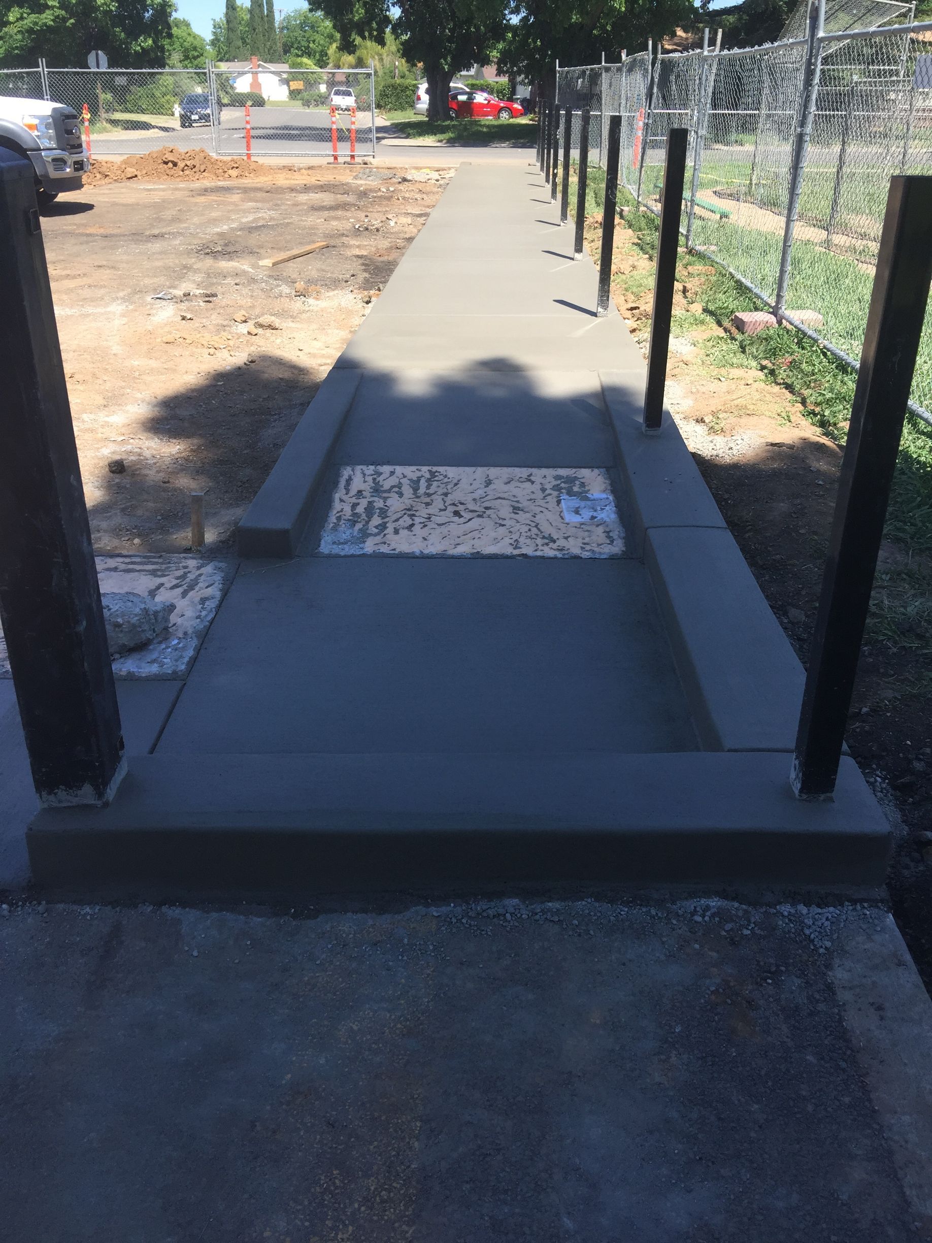 A concrete walkway with a handicap sign on it