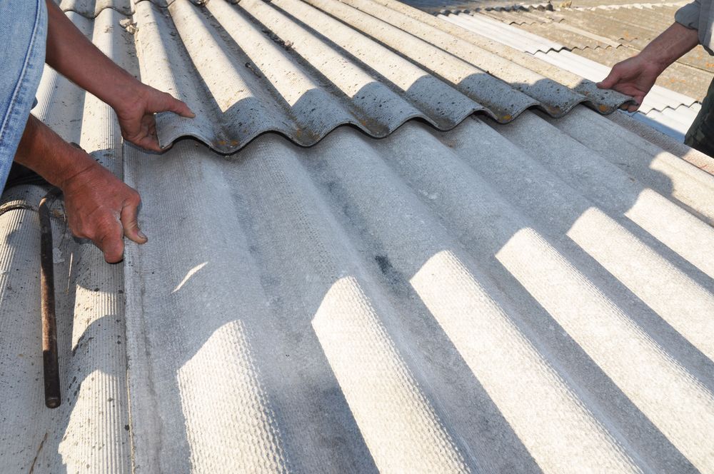 Two People Installing Corrugated Roofing Tiles — C&A Roofing In Tweed Heads, NSW