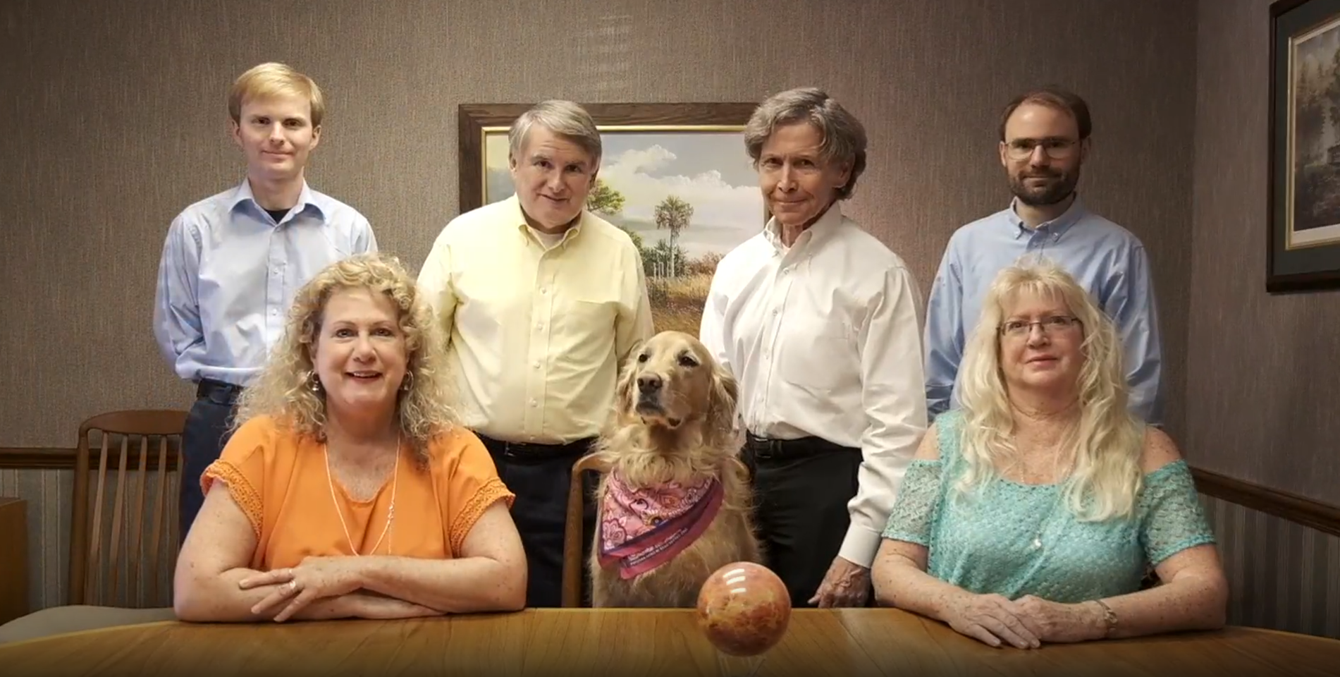 Golden scales of justice on a desk, next to a laptop, in an office setting.