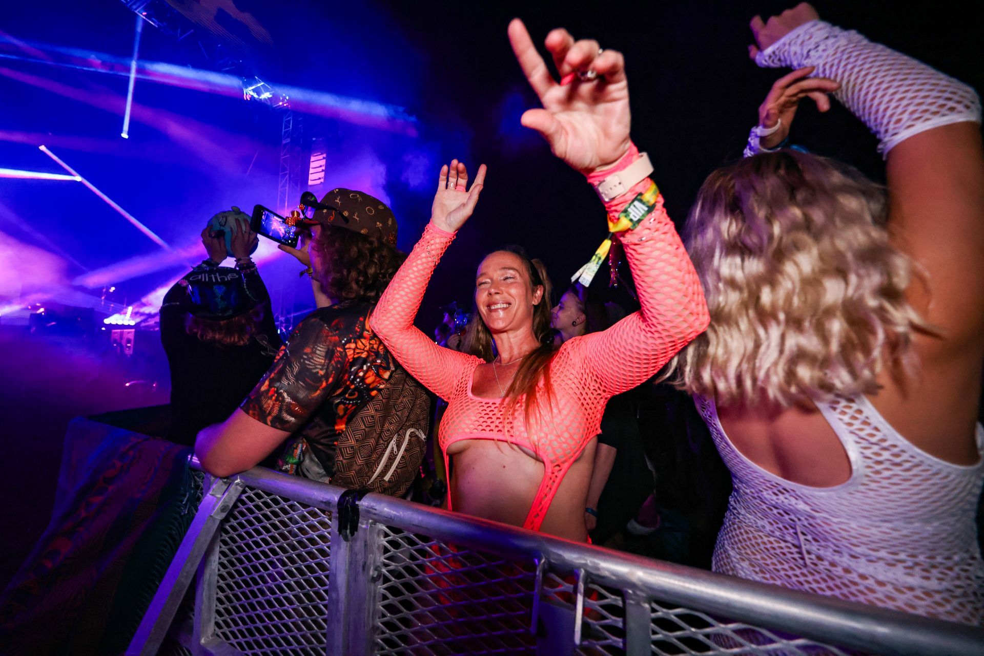 A group of people are dancing at a concert.