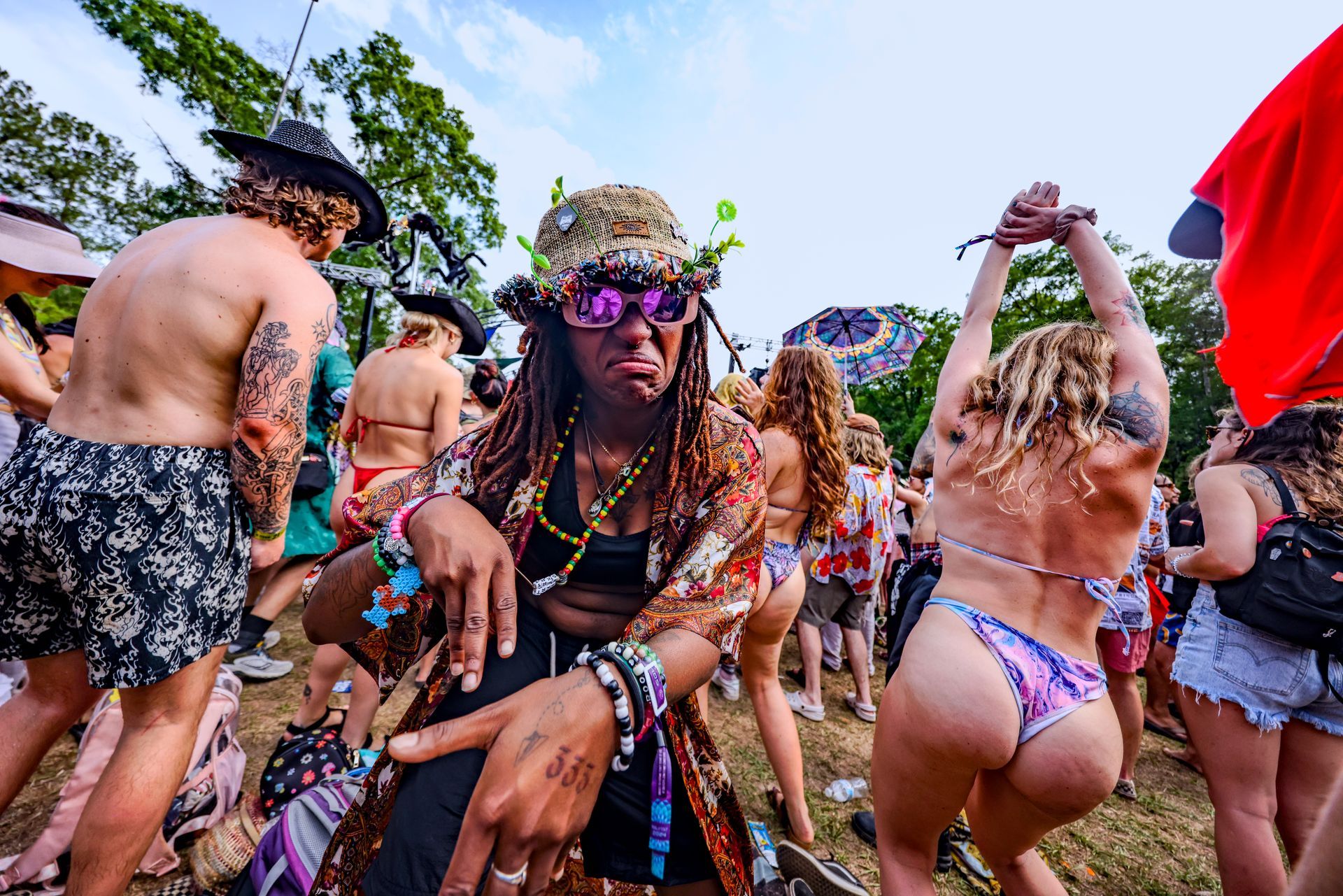 A group of people are dancing at a festival.