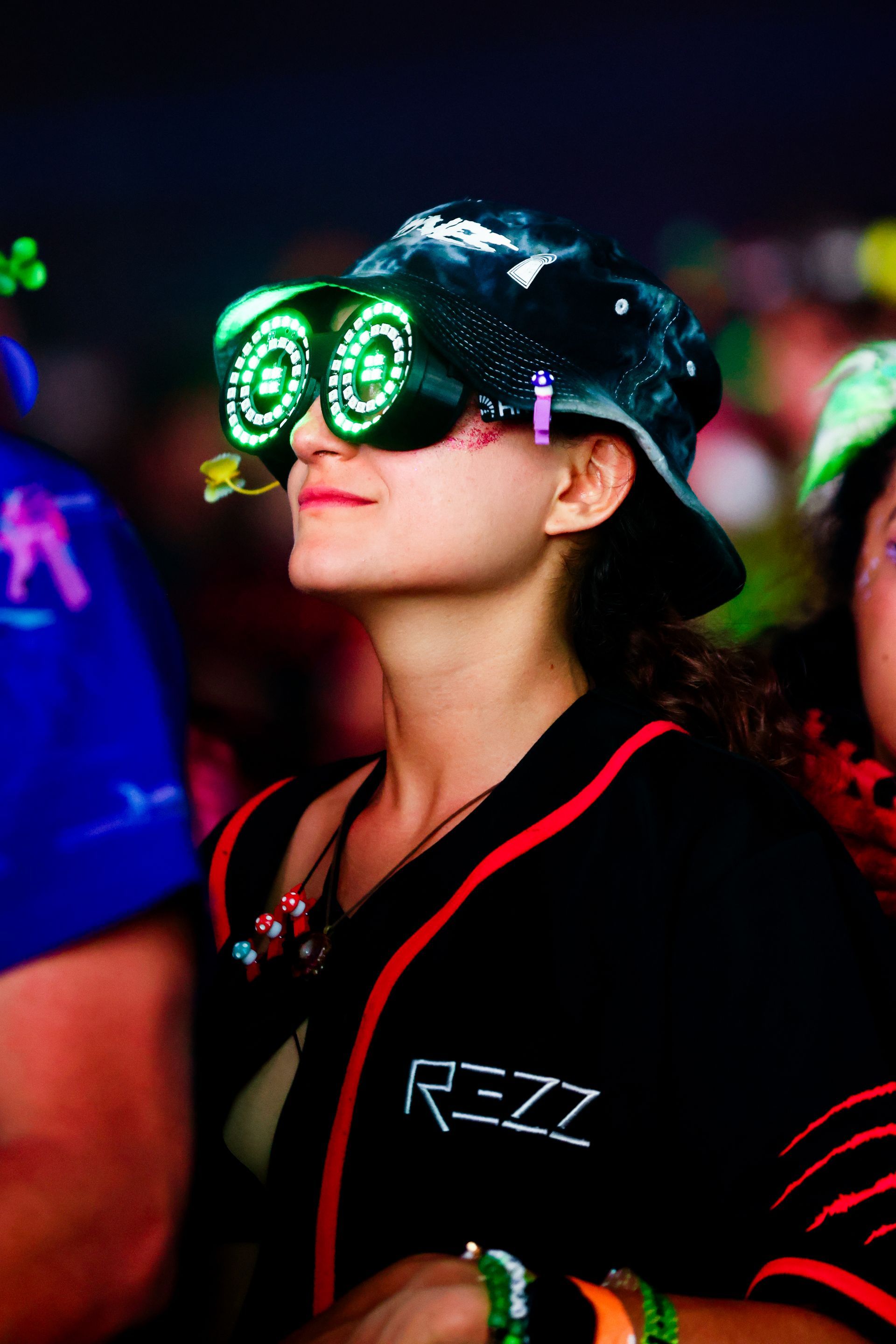A woman wearing a black shirt with the word rezz on it