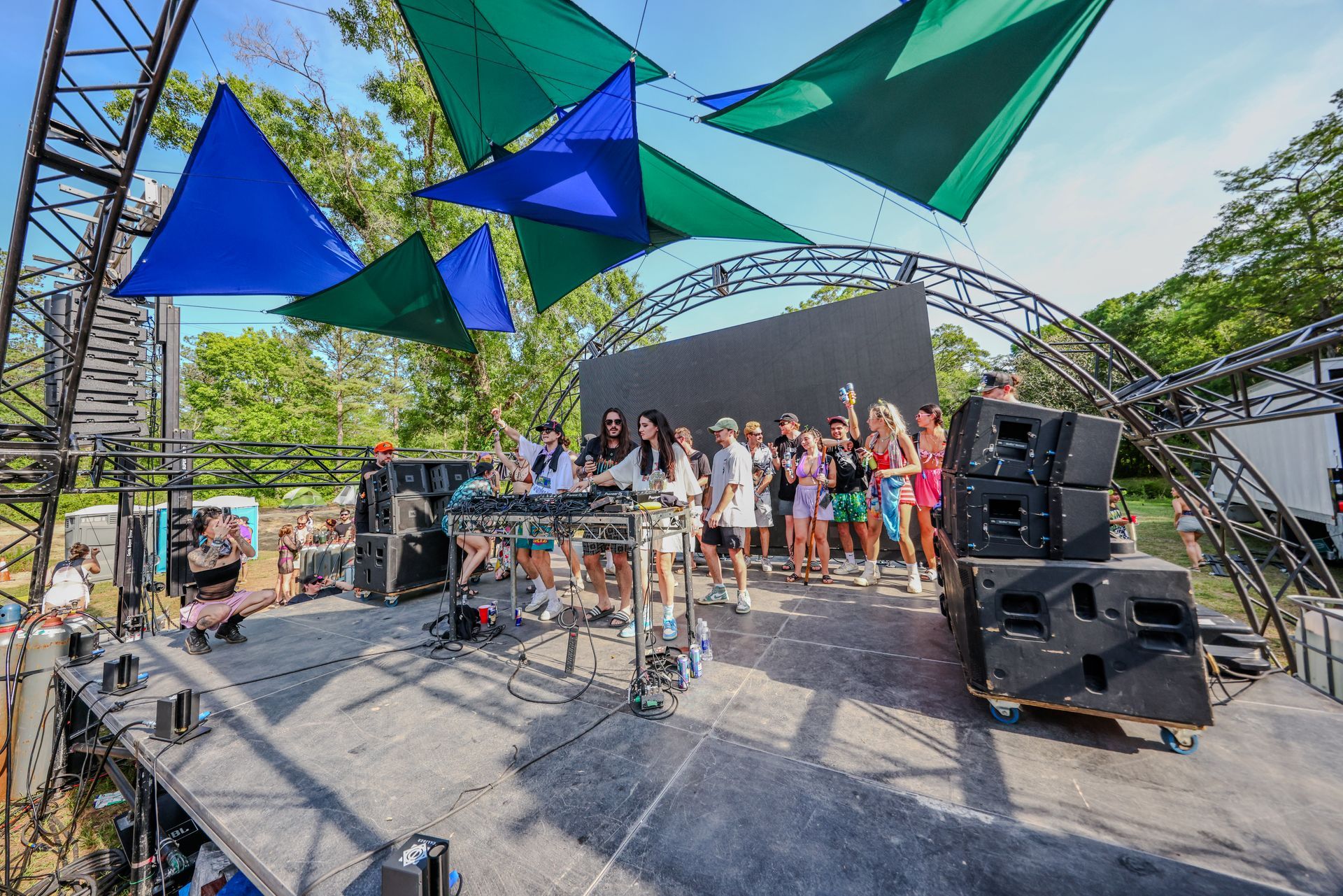 A group of people are standing on a stage at a concert.