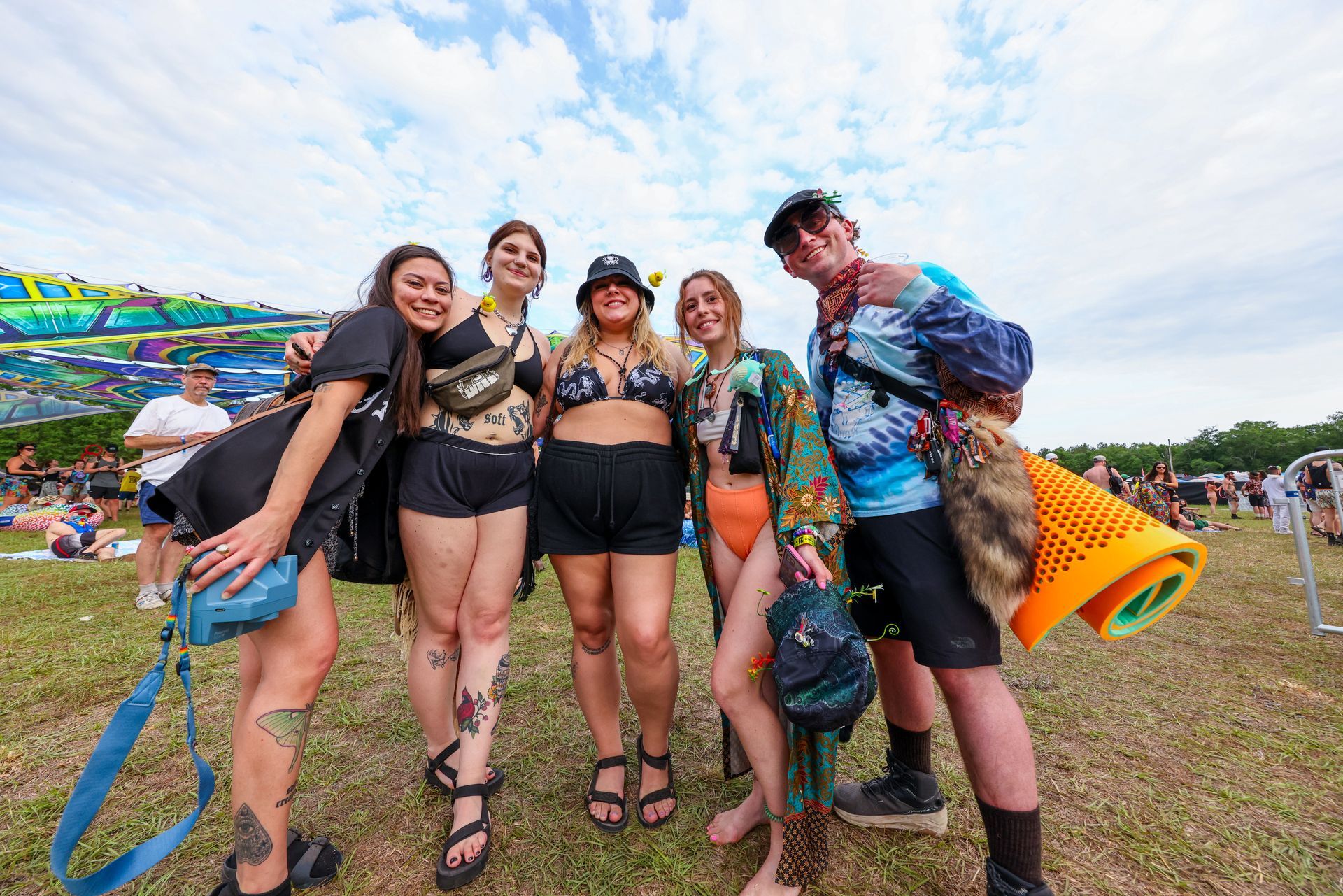 A group of people are posing for a picture at a festival.