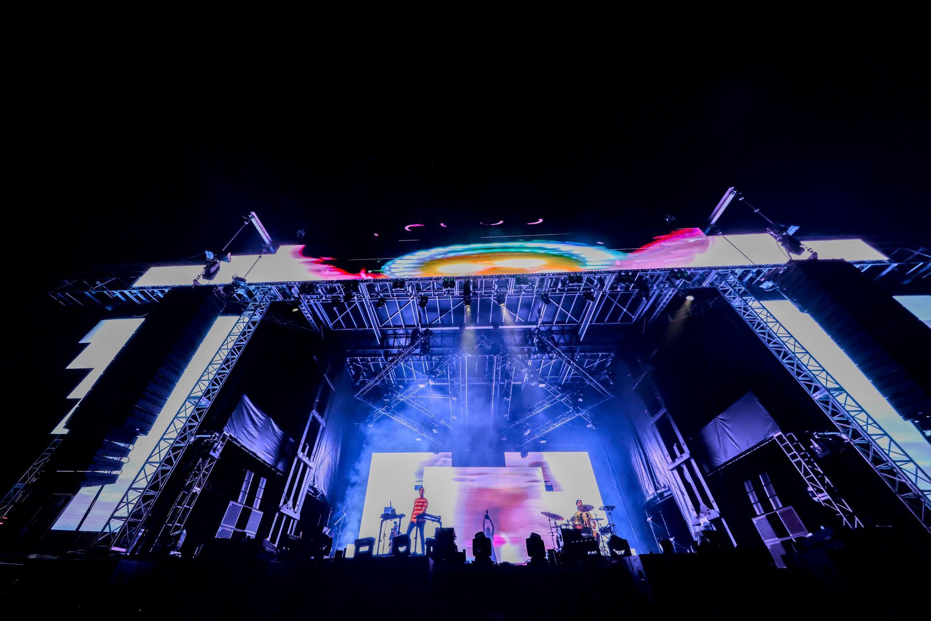 A group of people are standing on a stage at a concert.