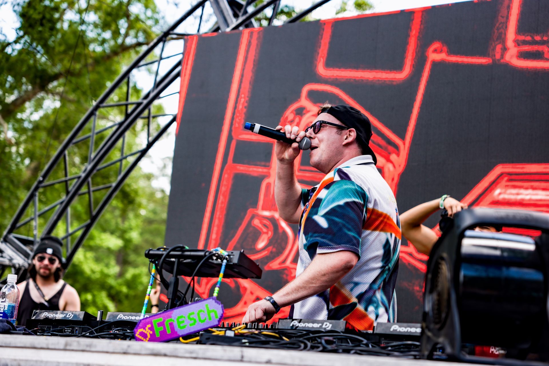 A man is singing into a microphone on a stage.