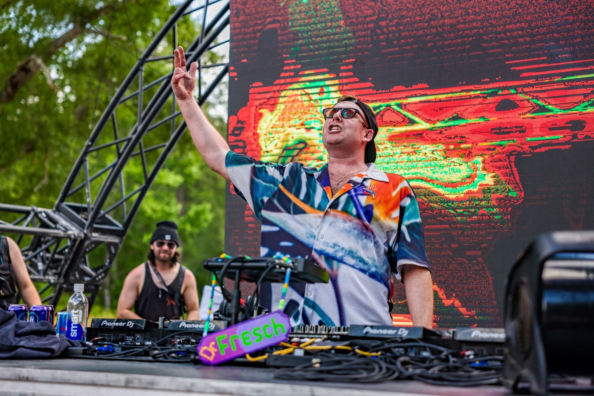 A man is standing on a stage in front of a large screen.